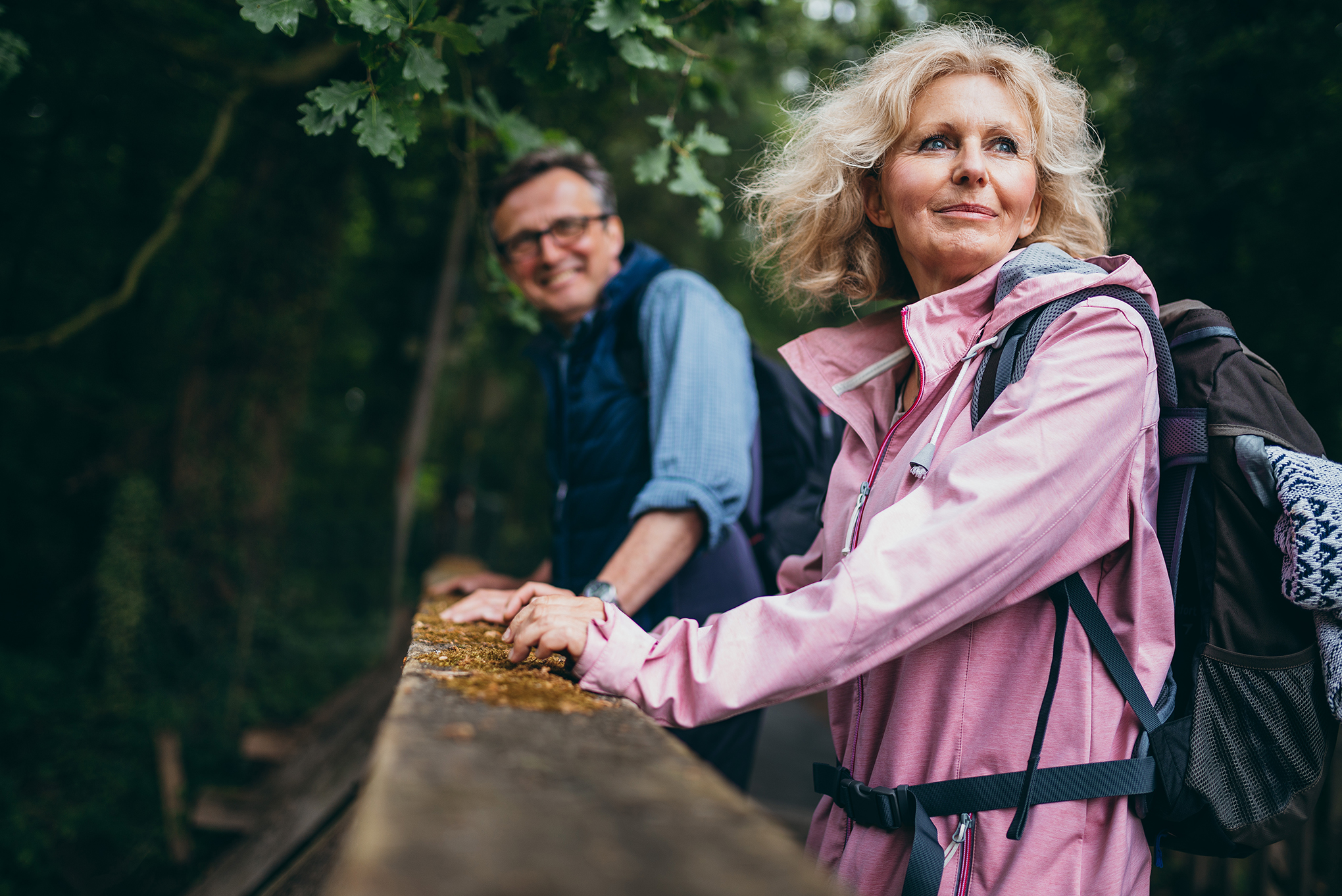Couple with backpacks on a bridge