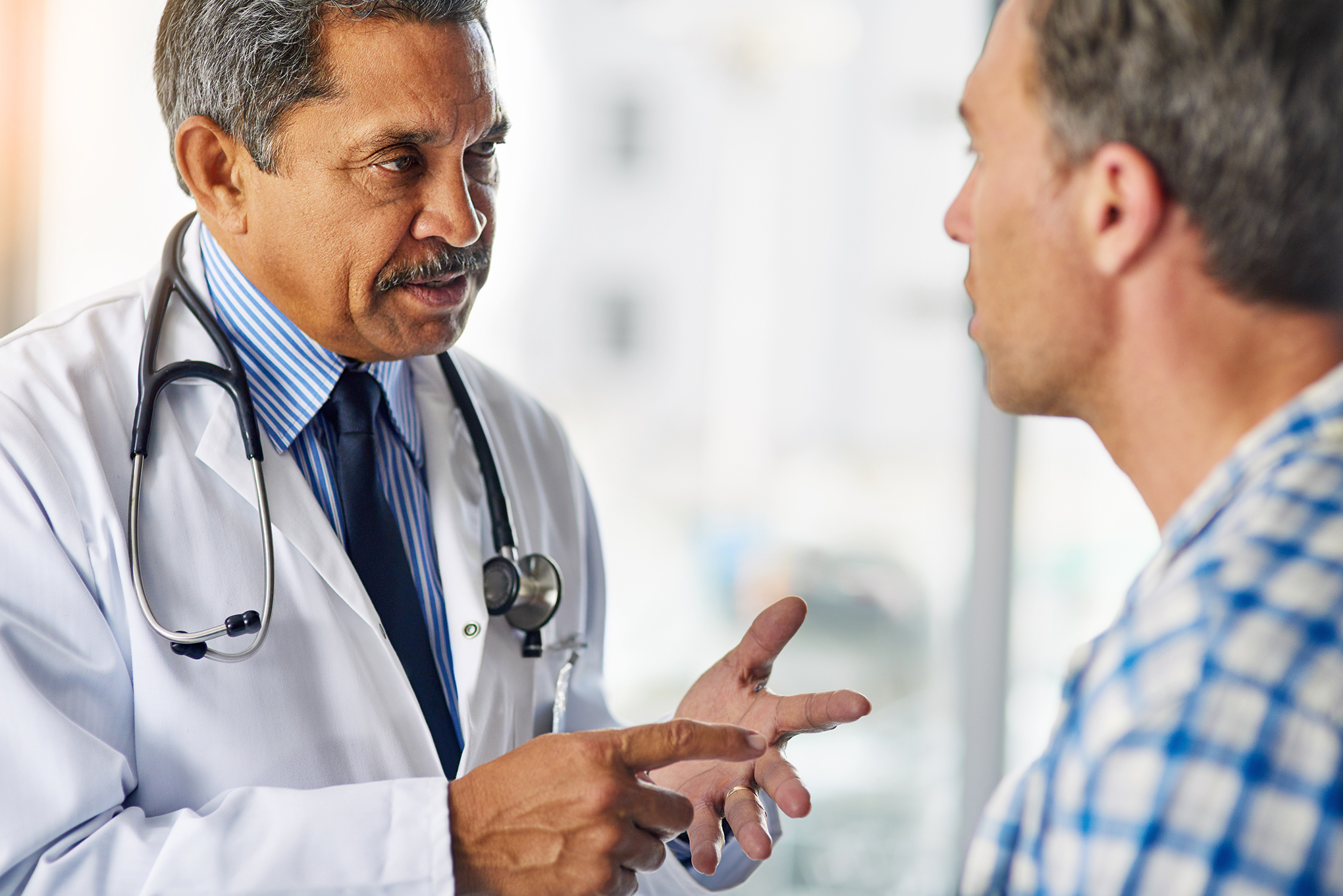 Physician talking with male patient