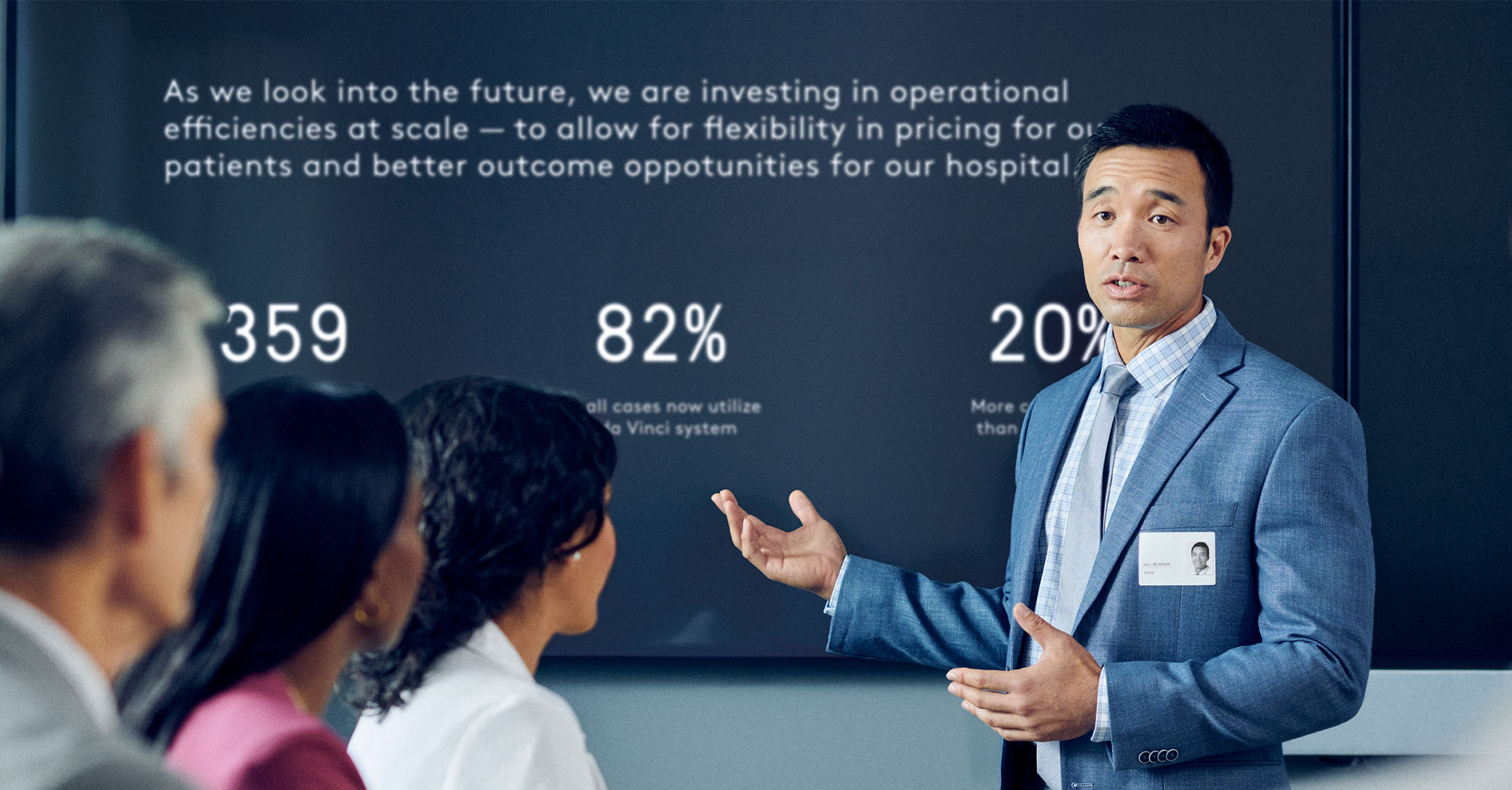 Executive presenting data to a room of peers.