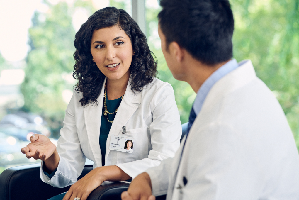 Female doctor speaking to colleague