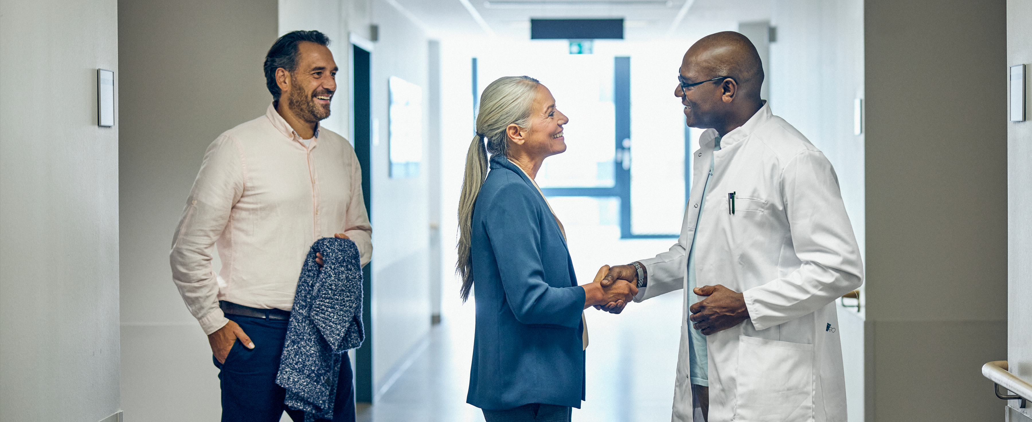 Surgeon and patient in hospital hallway
