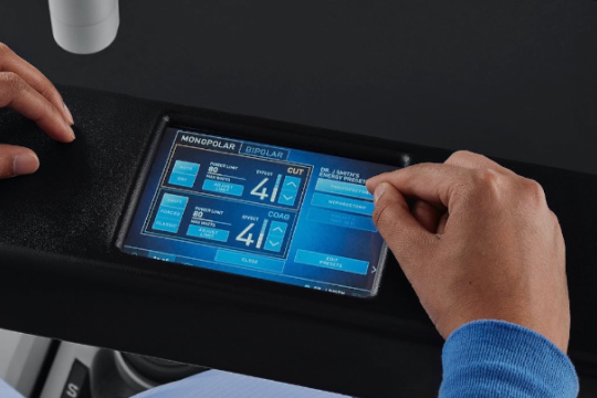 Hand touching screen on da Vinci X surgeon console