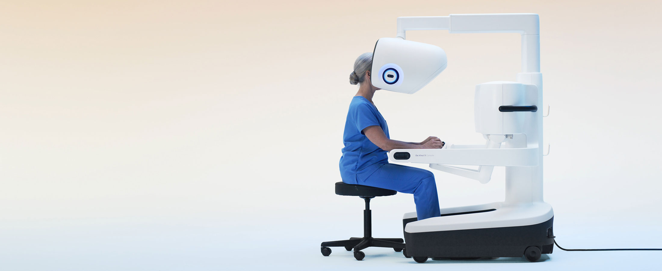 Pregnant surgeon seated at da Vinci 5 console