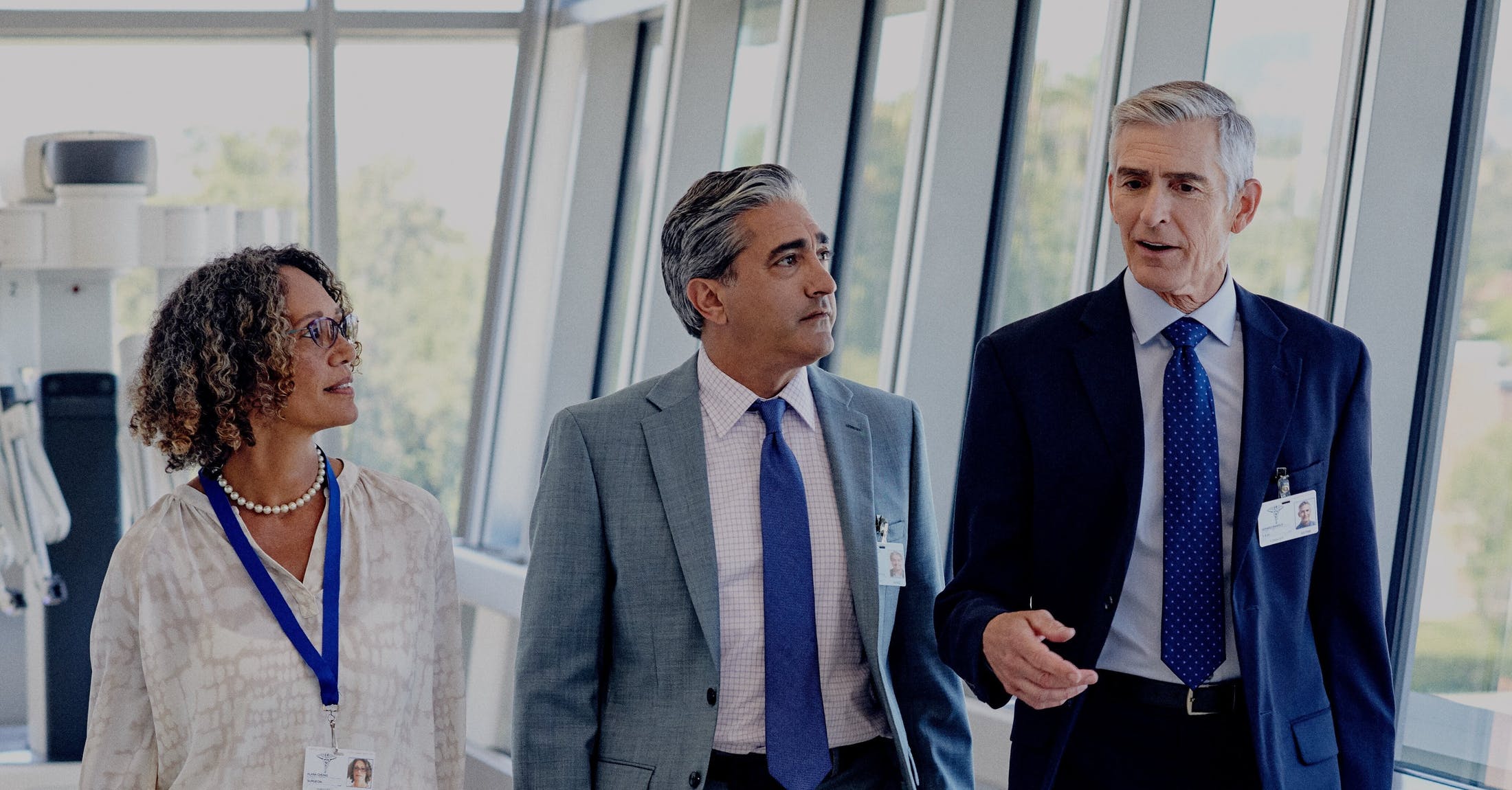 Three executives walking at an event