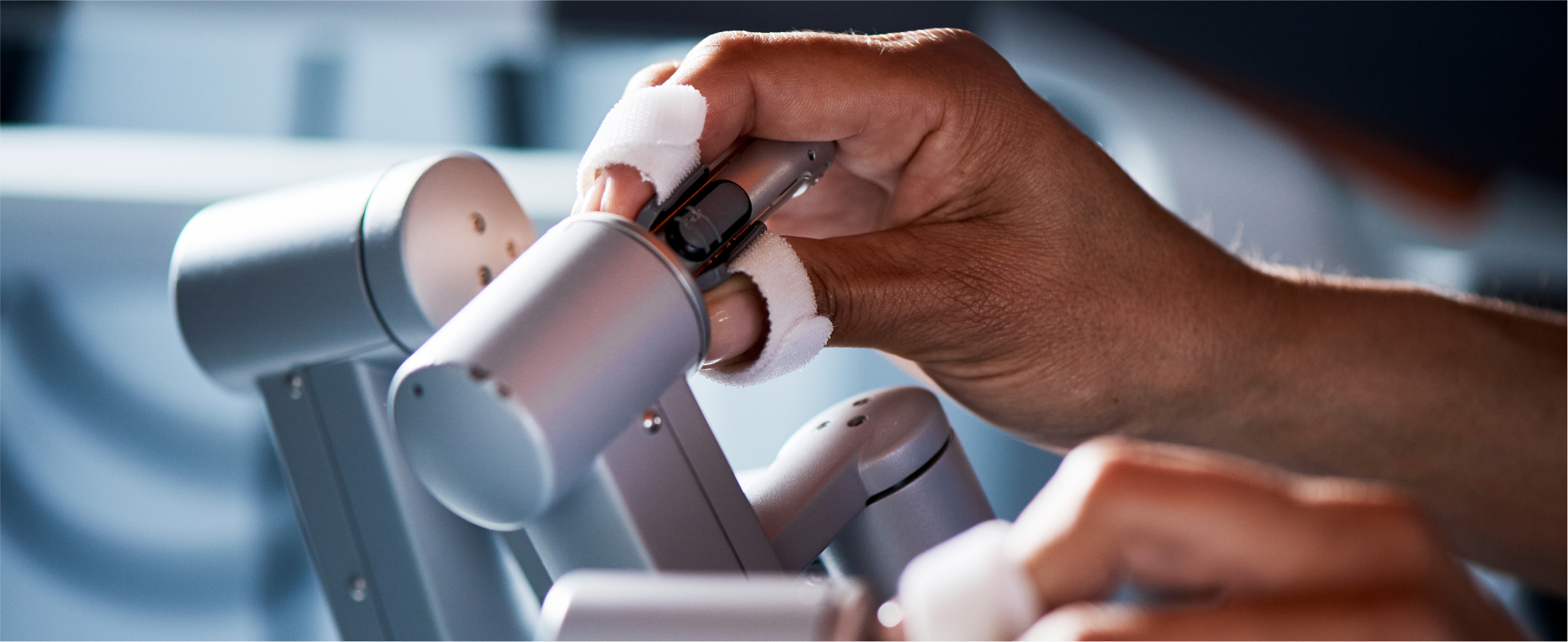 Image of  a surgeon’s hands manipulating the da Vinci controls