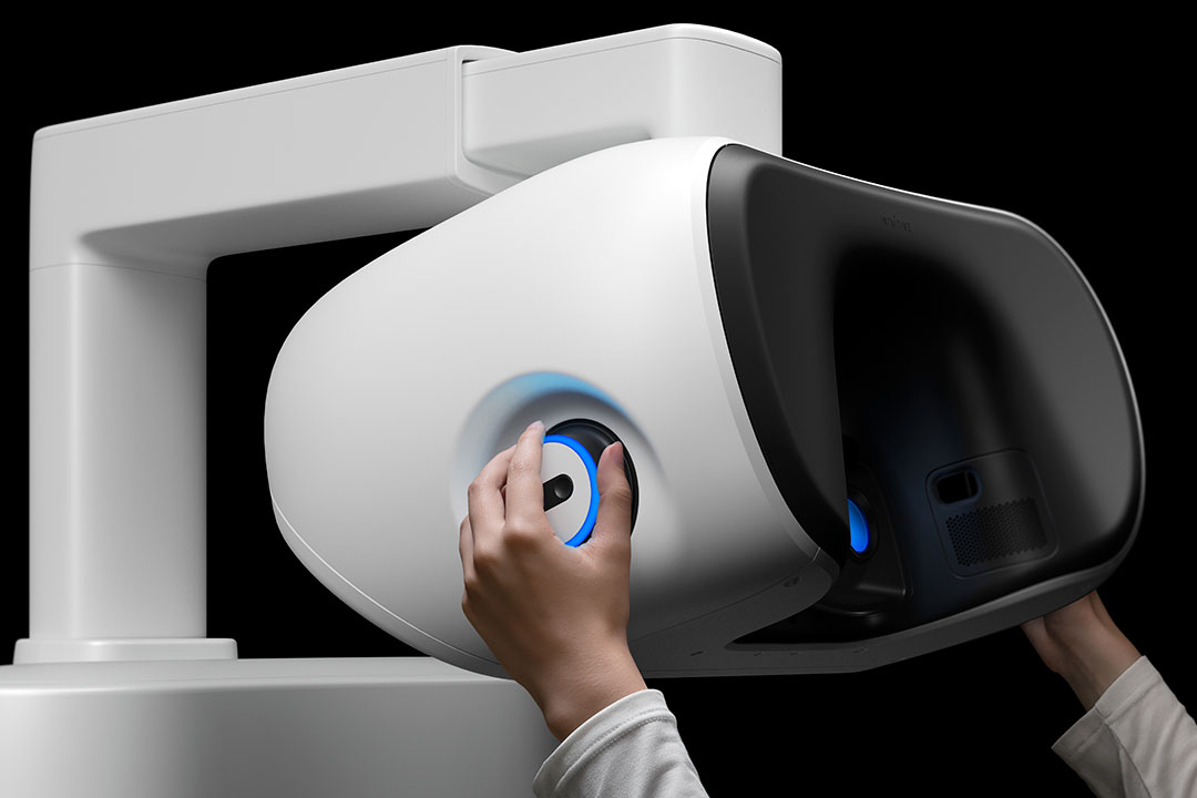 Surgeon manipulating da Vinci 5 surgeon console