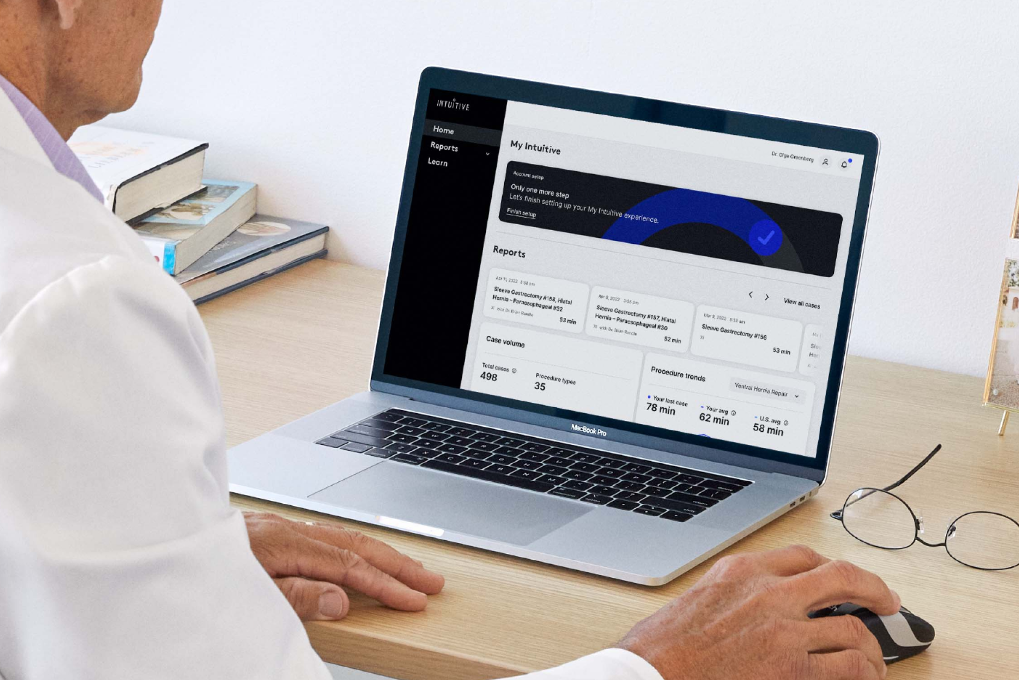 A surgeon accesses My Intuitive on a desktop computer