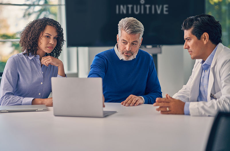 Surgeons in consultation with Genesis trainer.