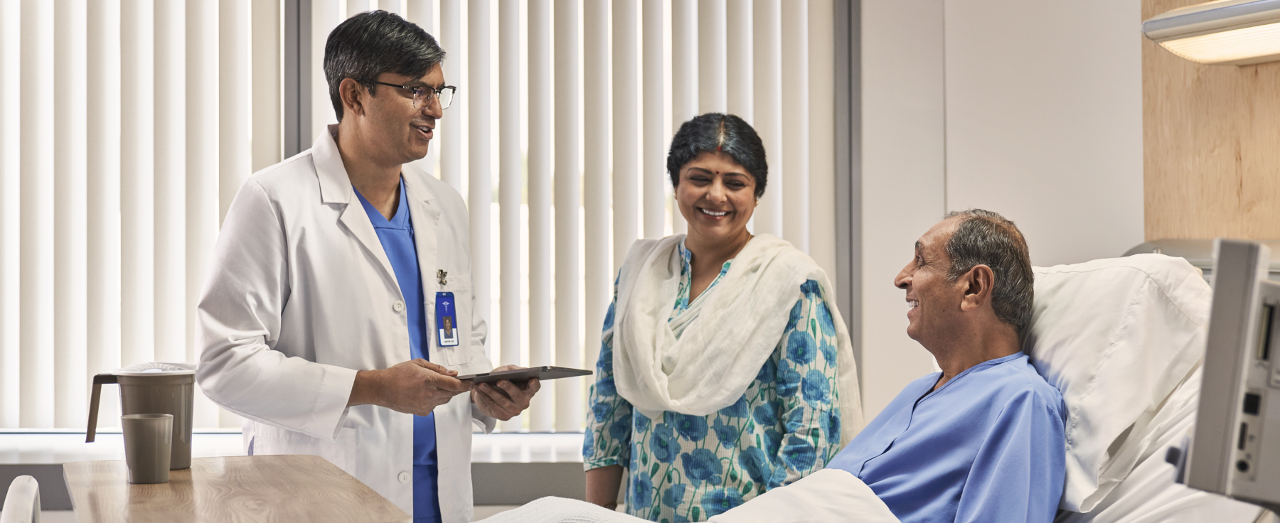 Doctor consulting patient and family in hospital room