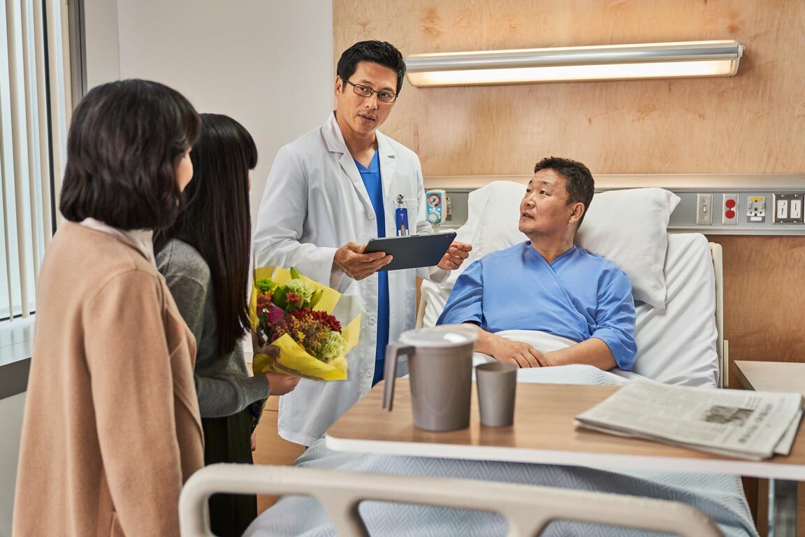 Surgeon consulting with patient and family
