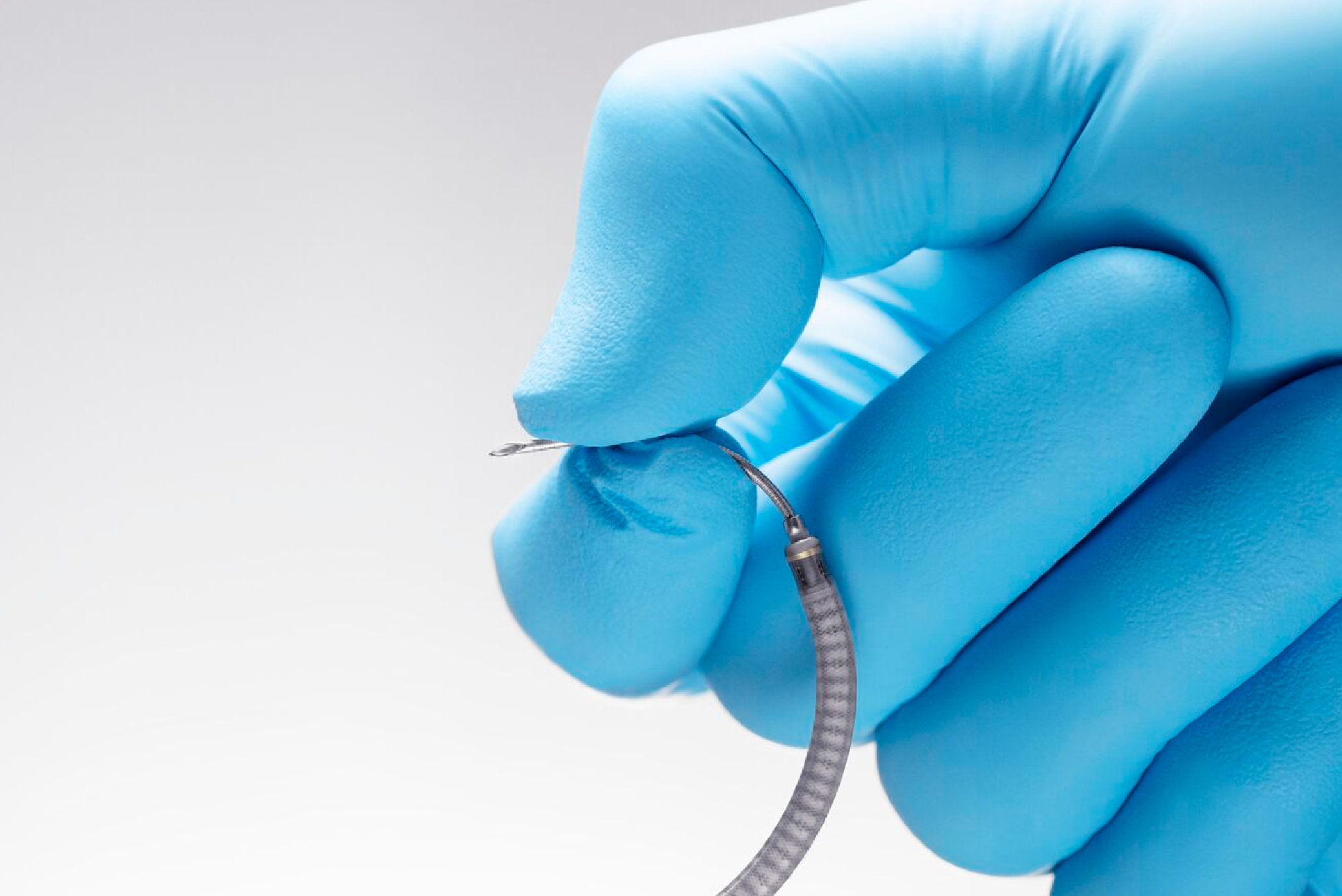 Hand holding the tip of the thin flexible Ion biopsy needle